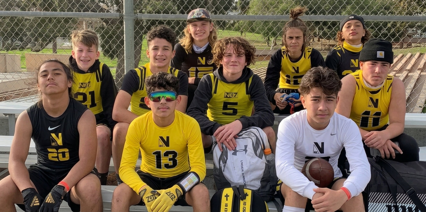 Teens sitting on bleachers in yellow and black uniforms.